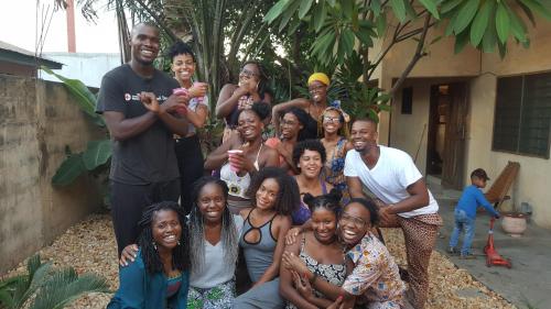 a group of people posing for a picture at La Guesthouse Étoile in Cotonou