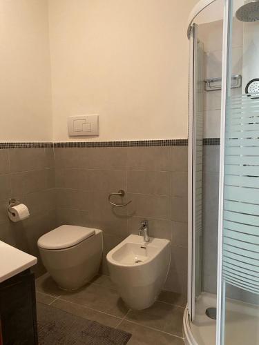 a bathroom with a toilet and a sink and a shower at Chirone Room in Mondello