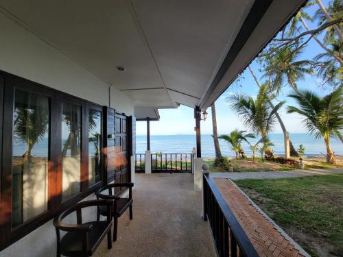 a view of the ocean from the porch of a house at Satva Samui Yoga and Wellness Resort in Amphoe Koh Samui