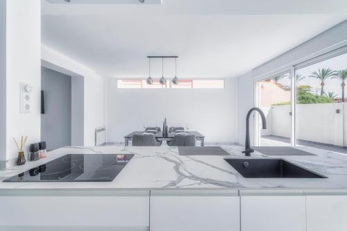 a white kitchen with a sink and a counter at Villa Fresno with Private Pool on gated 5* Mar Menor Golf Resort - 3 Bed/3 shower/WC in Torre-Pacheco