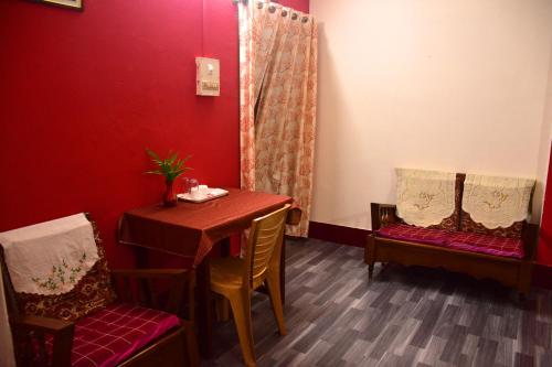 a dining room with a table and two chairs at J&B Homestay in Dibrugarh