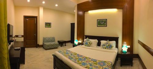 a bedroom with a large bed in a room at The Birder's Inn in Bharatpur