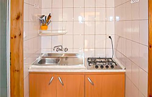 a small kitchen with a sink and a stove at Nice Apartment In Kopalino With 2 Bedrooms And Wifi in Kopalino