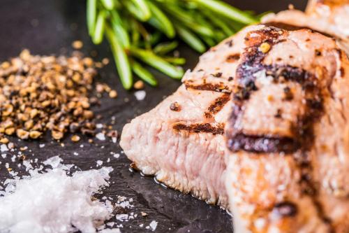 a close up of a piece of meat with green beans at Hotel Cristal Flumserberg in Flumserberg