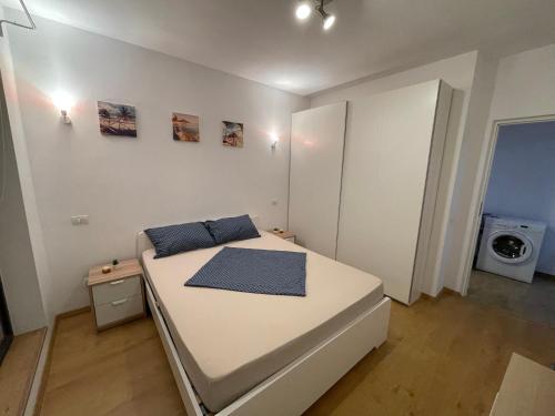 a white bedroom with a bed in a room at Energy Luxury Apartment Near Presidential Palace in Bucharest