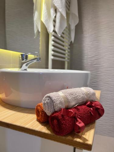 a bathroom counter with a sink and a towel at Energy Luxury Apartment Near Presidential Palace in Bucharest