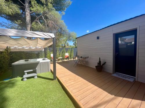 a backyard with a wooden deck with a grill at Suite La Farigoulette in Marseille