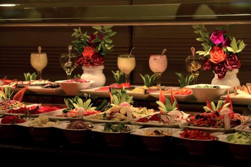 a buffet with many plates of food on a table at Pickalbatros Blu Spa Resort - Adults Friendly 16 Years Plus- Ultra All-Inclusive in Hurghada