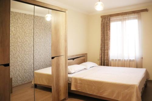 a bedroom with a bed and a window at Dilijan is for U in Dilijan