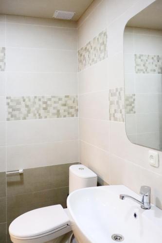 a bathroom with a white toilet and a sink at Dilijan is for U in Dilijan