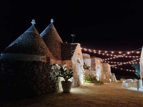 a night shot of a building with lights at Trulli Di Spinaruta in Grottaglie