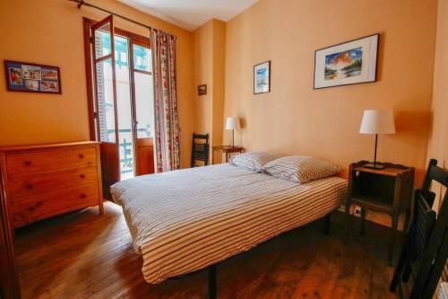 1 dormitorio con 1 cama, vestidor y ventana en Villa Señorita dans le quartier historique de Mers-les-Bains, 100m de la plage en Mers-les-Bains
