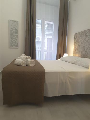 a hotel room with a bed with towels on it at A casa dei 3 in Catania