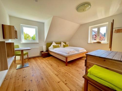 a bedroom with a bed and two windows at The Villetta in Petershausen