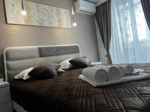 a bedroom with a bed with towels on it at Kharkovlux in Kharkiv