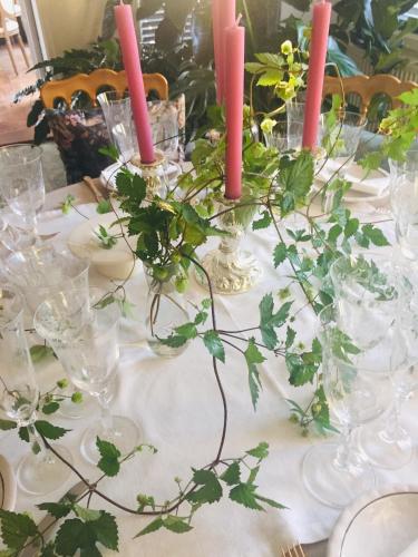 a table with wine glasses and candles on it at Huyze-peppins in Maldegem