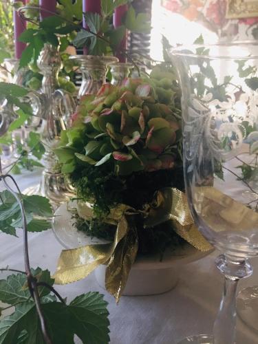 a glass vase with a plant in it on a table at Huyze-peppins in Maldegem