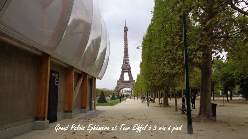a street with the eiffel tower in the background at Hotel Royal Phare in Paris