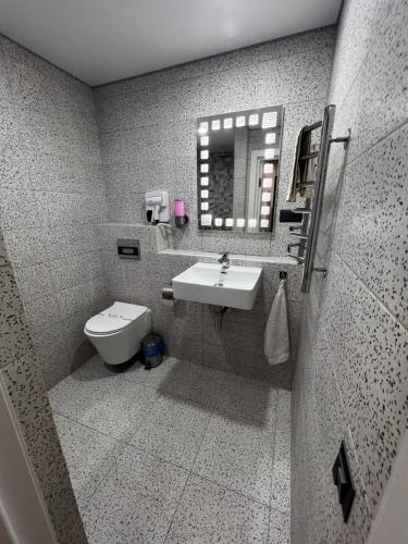 a bathroom with a sink and a toilet at Kharkovlux in Kharkiv