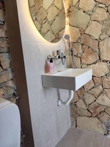 a bathroom with a sink and a mirror at Stone House in Triopetra