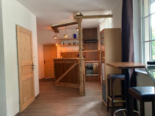 a kitchen with wooden cabinets and a wooden door at Perschlingtalhof in Auern