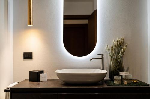 a bathroom with a large bowl sink on a counter at Sibenbras Natural Aparthotel in Limone sul Garda