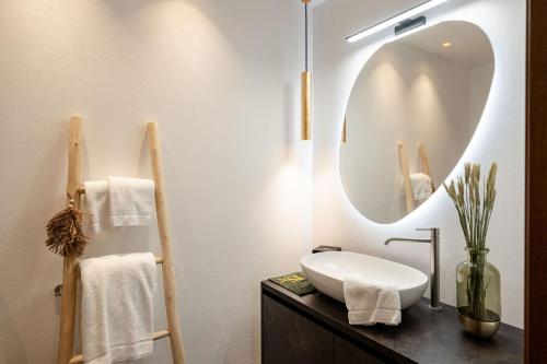 a bathroom with a sink and a mirror at Sibenbras Natural Aparthotel in Limone sul Garda