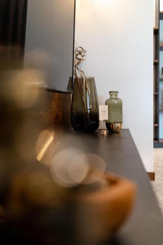 a counter with two vases sitting on top of it at Sibenbras Natural Aparthotel in Limone sul Garda