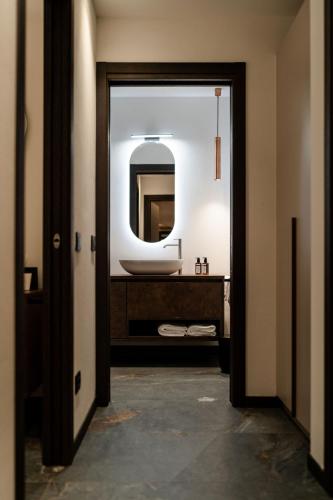 a bathroom with a sink and a mirror at Sibenbras Natural Aparthotel in Limone sul Garda