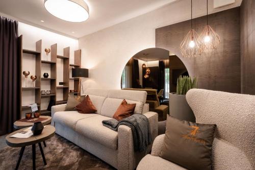 a living room with a couch and a table at Sibenbras Natural Aparthotel in Limone sul Garda