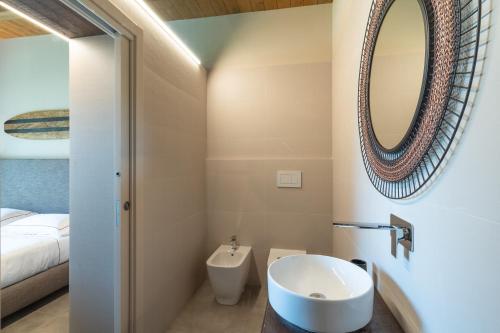 een badkamer met een wastafel en een spiegel bij Hang Loose Cottage in Gizzeria