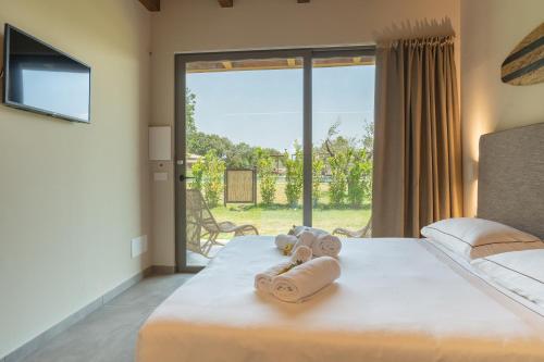 a bedroom with a bed with rolled towels on it at Hang Loose Cottage in Gizzeria