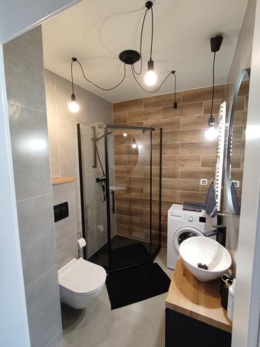 a bathroom with a toilet and a sink and a shower at N° 59 in Płock