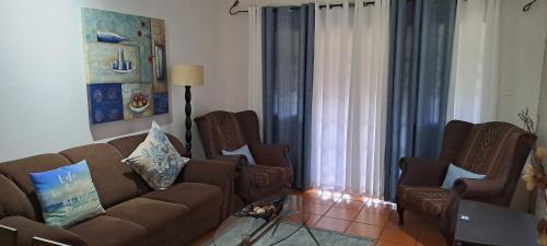 a living room with a couch and two chairs at The Courthouse in Ramsgate