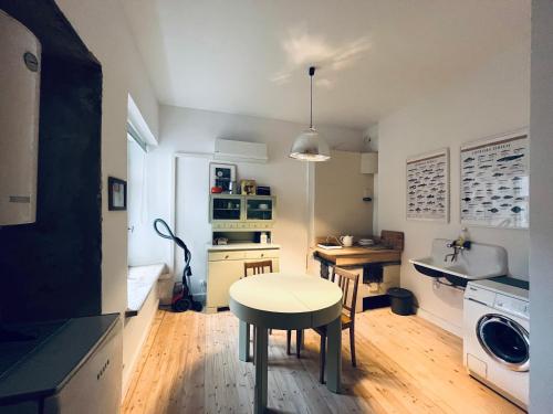 a kitchen with a table and a small table in it at Old Town Apartment in Cēsis