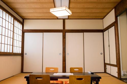 a dining room with a table and chairs at Guesthouse Sunline Beppu in Beppu