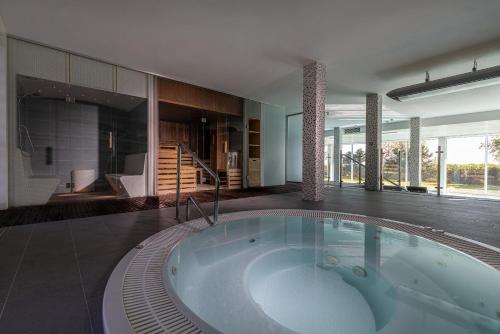 a large bathroom with a large tub in a room at Hotel Meridian in Chałupy