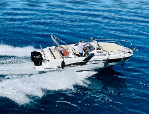 two people in a speed boat on the water at Villa Palladium in Makarska