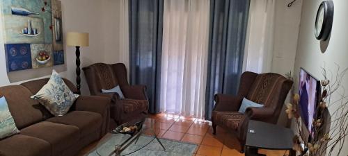 a living room with a couch and two chairs at The Courthouse in Ramsgate