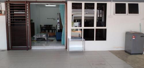 an open door to a room with a window and a refrigerator at Homestay Jerantut Sincerelyat in Jerantut