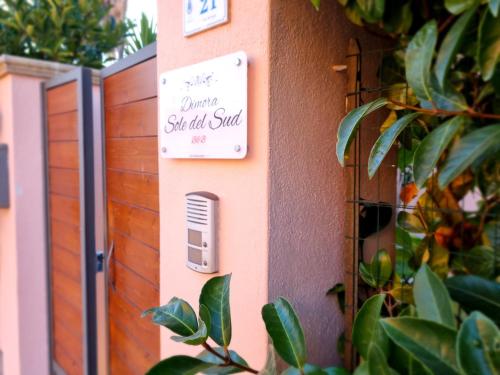 a sign on the side of a building with plants at Dimora Sole del Sud in Ugento