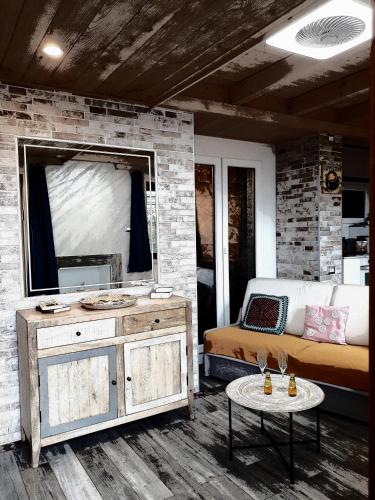 a room with a bed and a mirror and a table at Sole & Lago-Lake in Maccagno con Pino e Veddasca