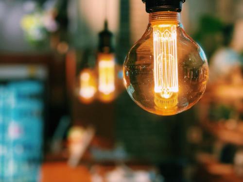 a close up of a light bulb hanging from a ceiling at Guesthouse Sunline Beppu in Beppu