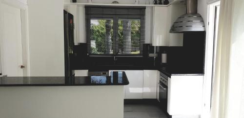 a kitchen with a black counter top and a window at Villa Amadeus Xabia in Balcon del Mar