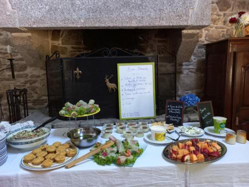 a table with many plates of food on it at Ti Dour - Gîte de charme à la campagne - côte de granit rose in Bégard