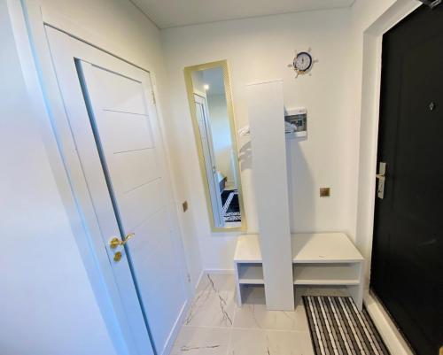 un corridoio con porta bianca e specchio di MMA apartament & sauna 