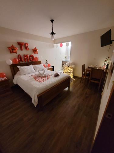 a bedroom with a bed with red decorations on the wall at Quinta San Felipe in Tababela