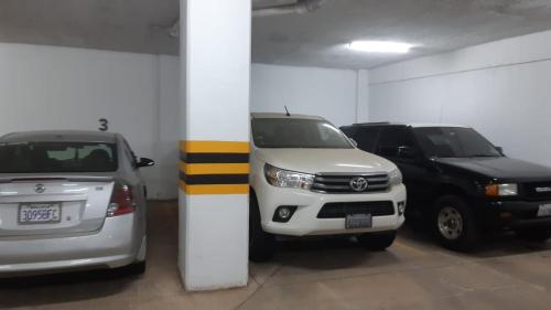 a parking garage with two cars parked in it at Mi casa es tu casa ! in Santa Cruz de la Sierra