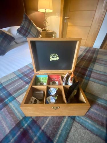 a wooden box on top of a bed at Ravelston House in Musselburgh