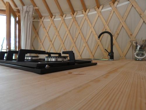 a black object sitting on top of a wooden floor at Romantic yurt in Apuseni mountains in Grohoţele